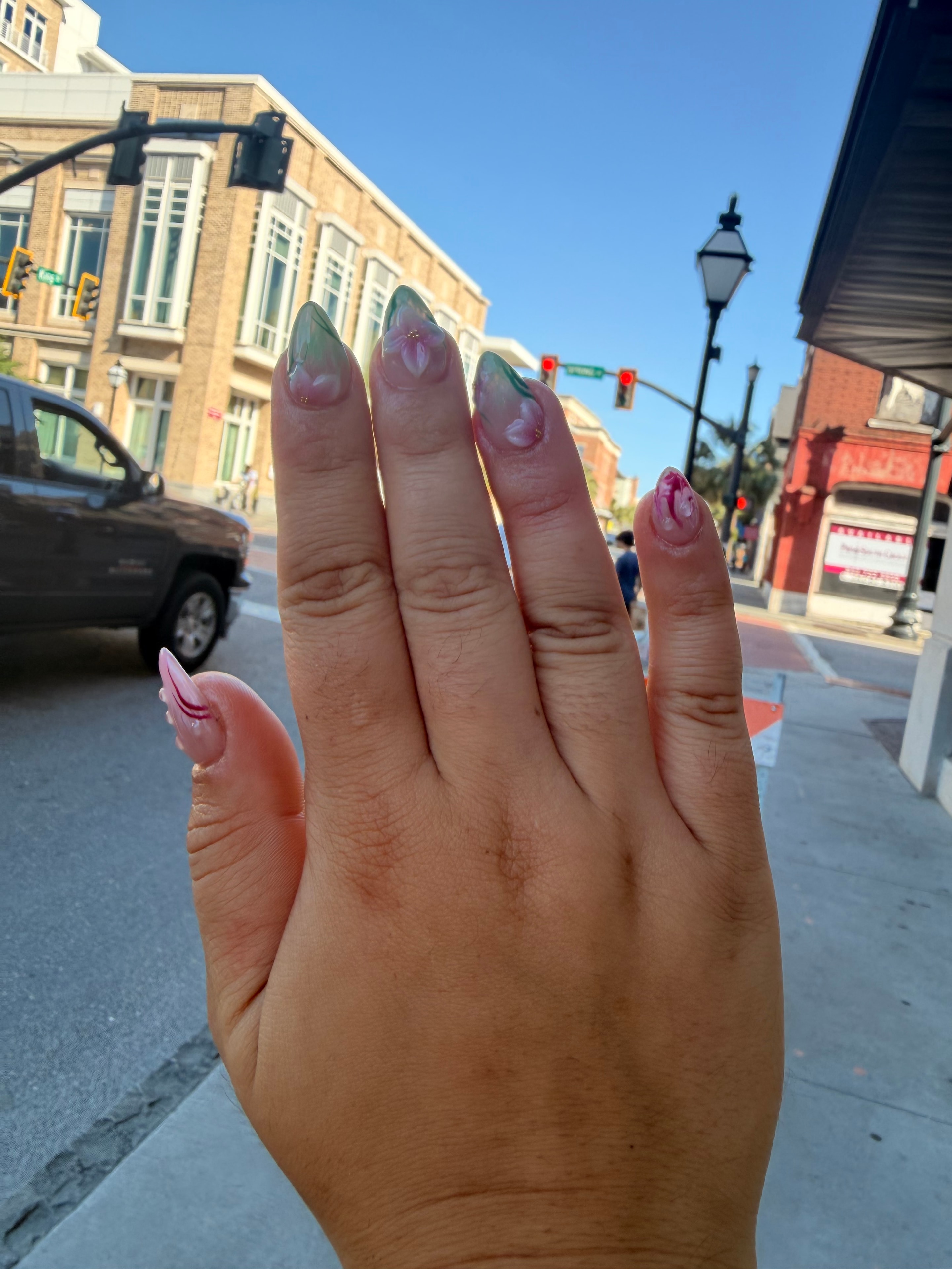 Black stiletto nails with chrome gold detail