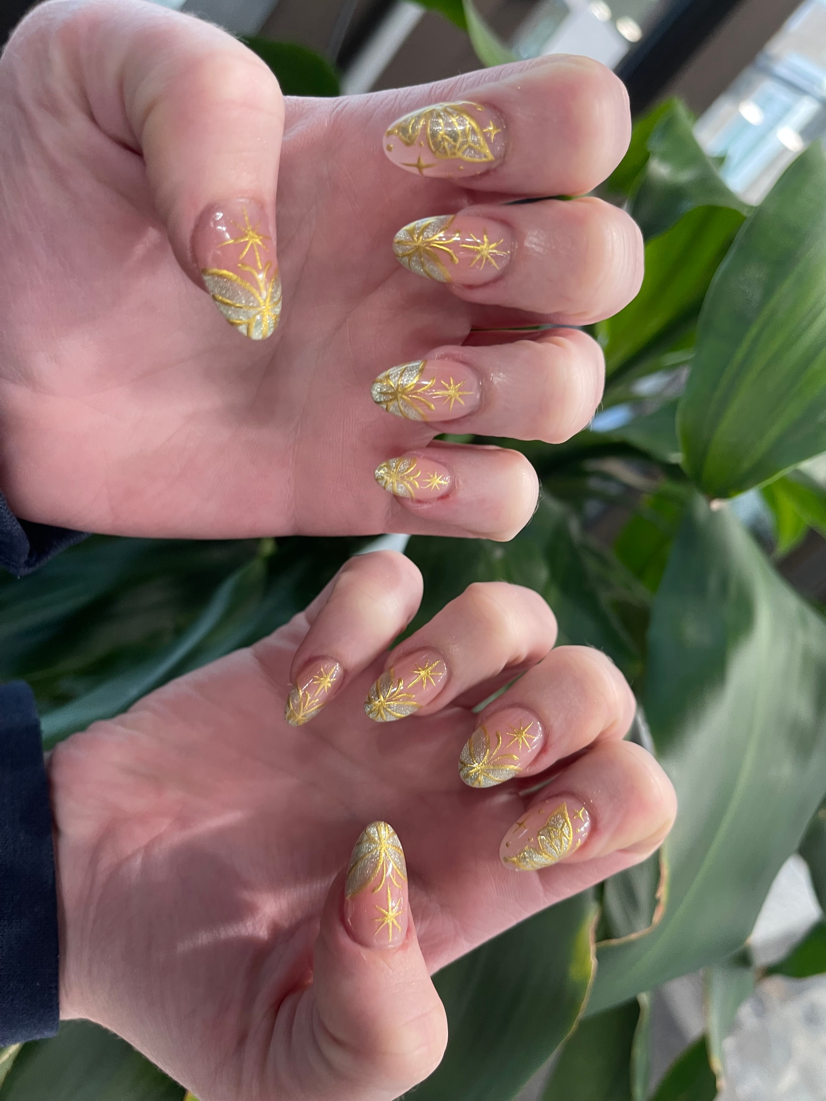Black nails with gold filigree and glitter design