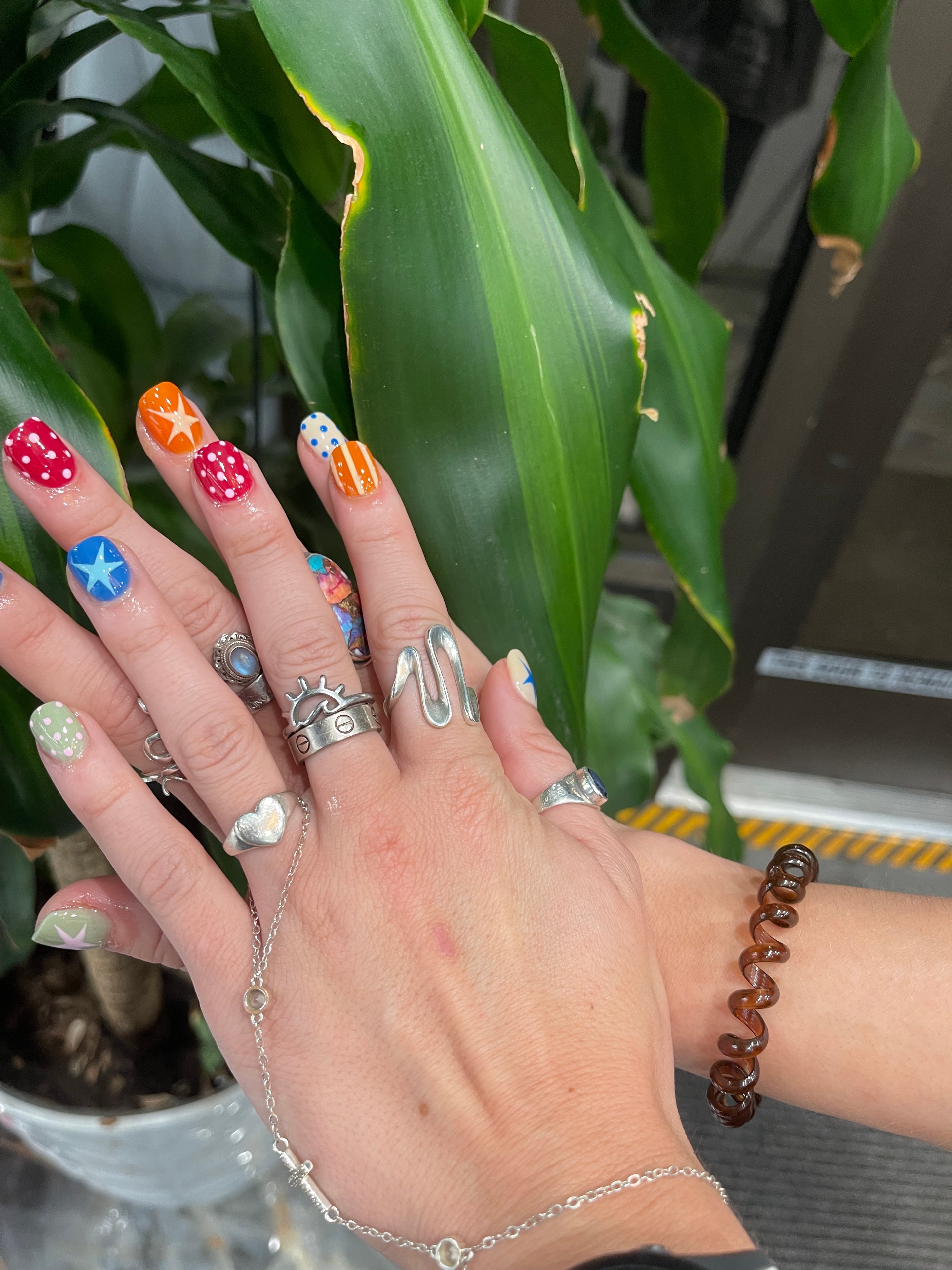 Black nails with rhinestone and metallic accents